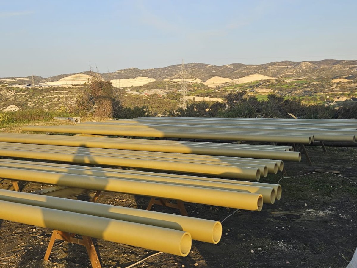 Industrial pipes painted yellow/olive, ready for installation on site
